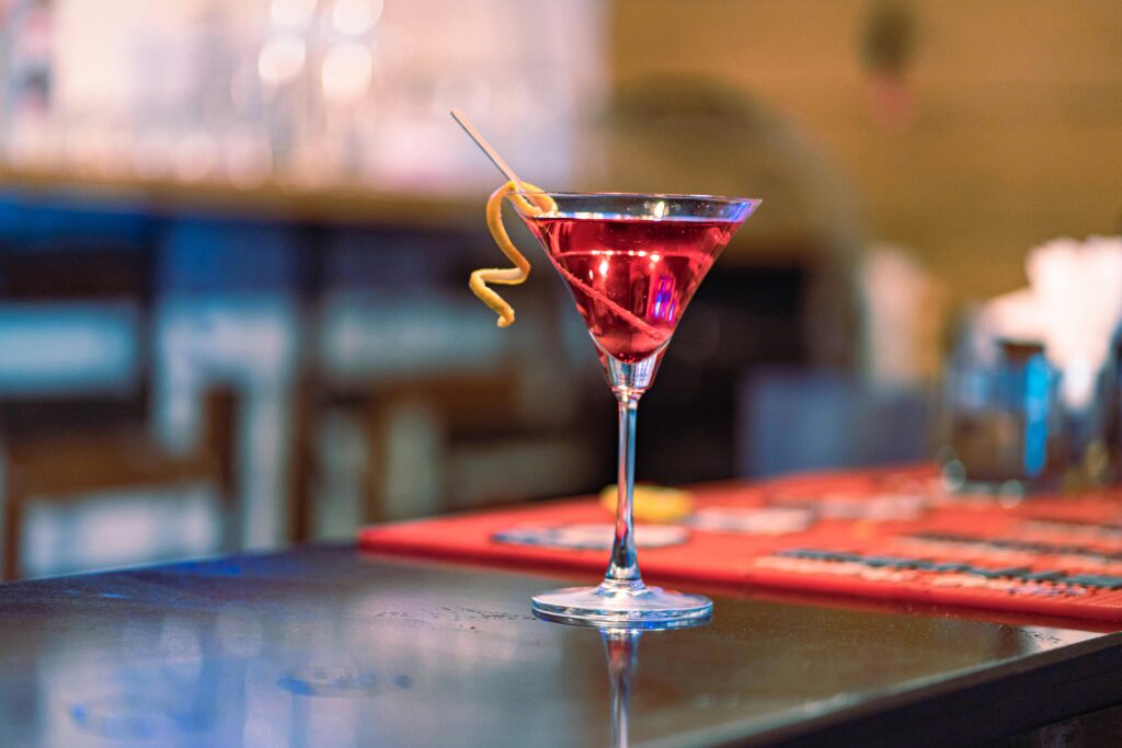 Top 5 Signature Cocktails You Must Try at SV LUXE RESORT Stylish cocktail with garnish on a bar counter, ideal for nightlife themes.